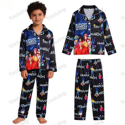 Boy wearing black satin K-Pop Demon Hunters pajamas with long sleeves and character print.