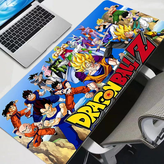 Vibrant Dragon Ball Z warriors collage XXL gaming mouse pad on a modern desk setup with a laptop.