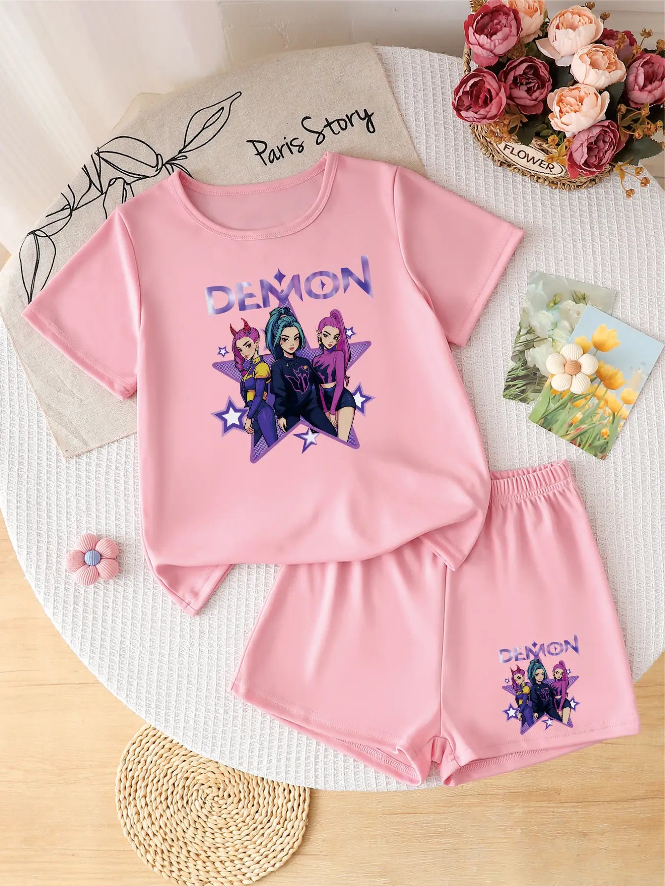 Two-piece pink girls' summer set featuring a purple 'Demon' anime idol group graphic on the t-shirt and shorts.