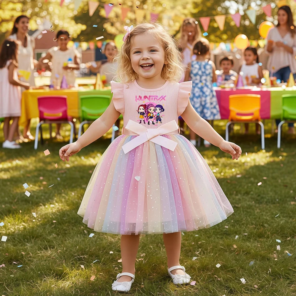Toddler girl wearing a rainbow tulle K-Pop HUNTRX princess dress with sequins and a satin bow.