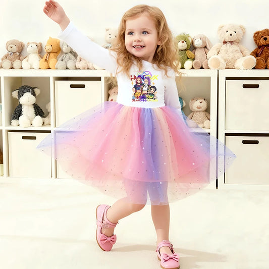 Toddler girl in a white long-sleeve K-Pop Demon Hunters dress with a rainbow star-sequined tutu skirt.
