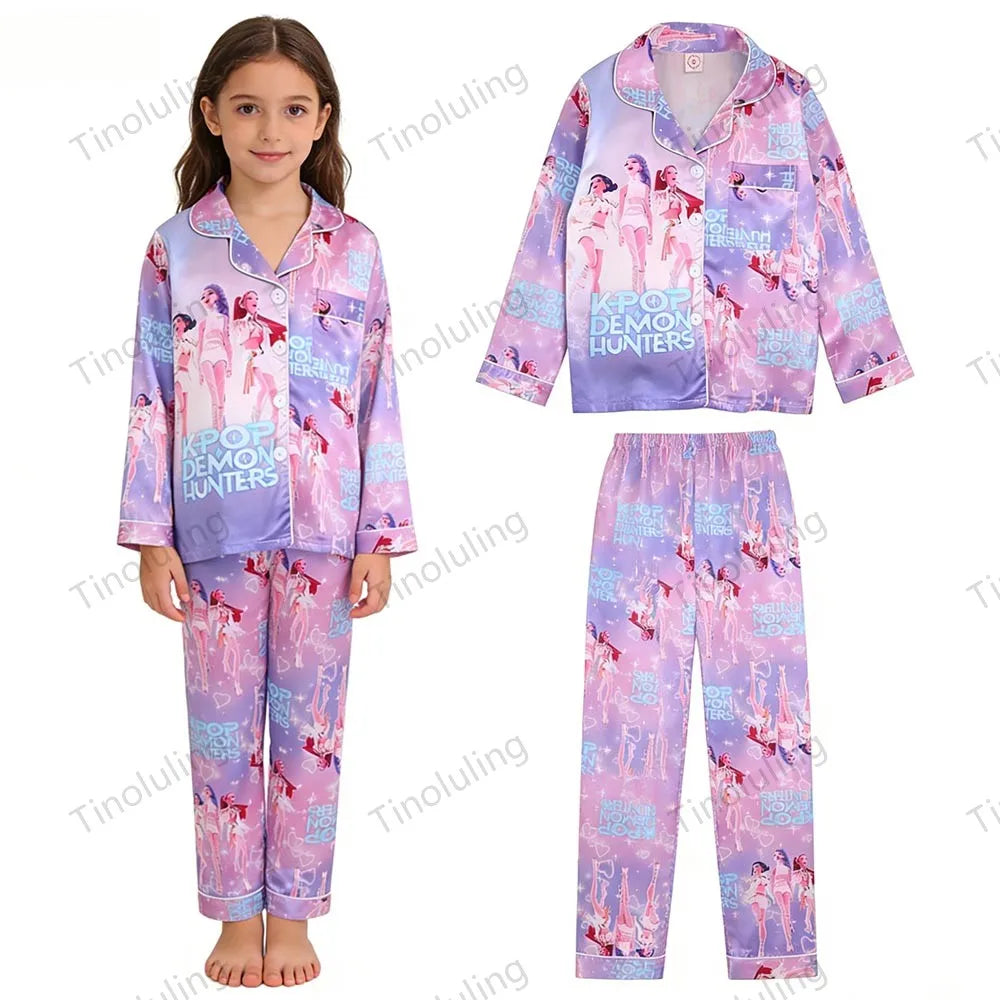 Girl wearing purple/pink satin K-Pop Demon Hunters pajamas with long sleeves and idol graphic.