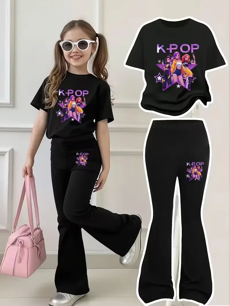 Young girl wearing a black K-Pop graphic t-shirt and matching black flared bell-bottom pants.