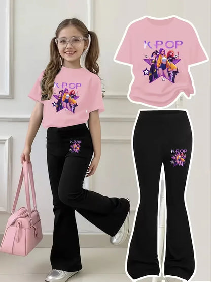 Young girl wearing a light pink K-Pop graphic tee and matching black flared bell-bottom pants.