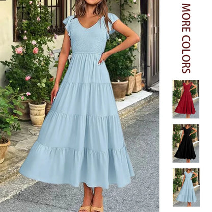 Light blue fashionable maxi dress with V-neck, butterfly sleeves, and pleated tiered skirt with color variations.