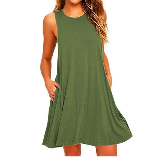 Woman wearing a green sleeveless summer swing t-shirt dress with side pockets on a white background.