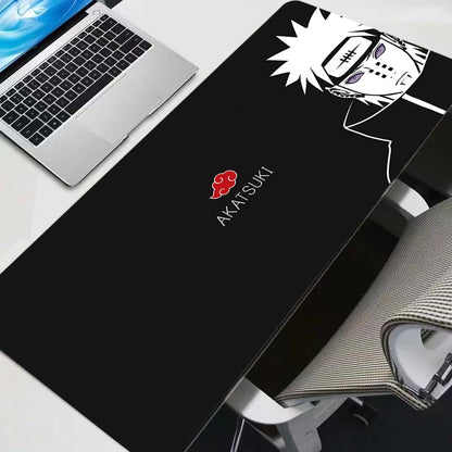 Minimalist black and white Pain Akatsuki XXL gaming mouse pad on a white desk with a laptop.