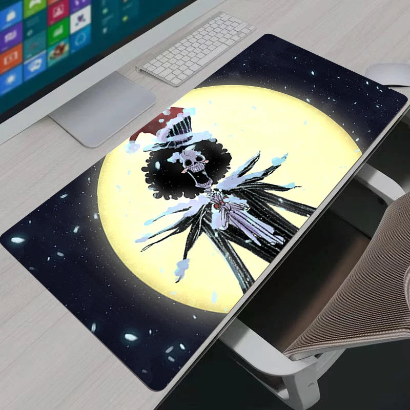 Artistic One Piece Brook moonlight XXL gaming mouse pad on a modern desk setup with a keyboard.