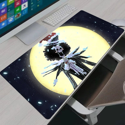 Artistic One Piece Brook moonlight XXL gaming mouse pad on a modern desk setup with a keyboard.