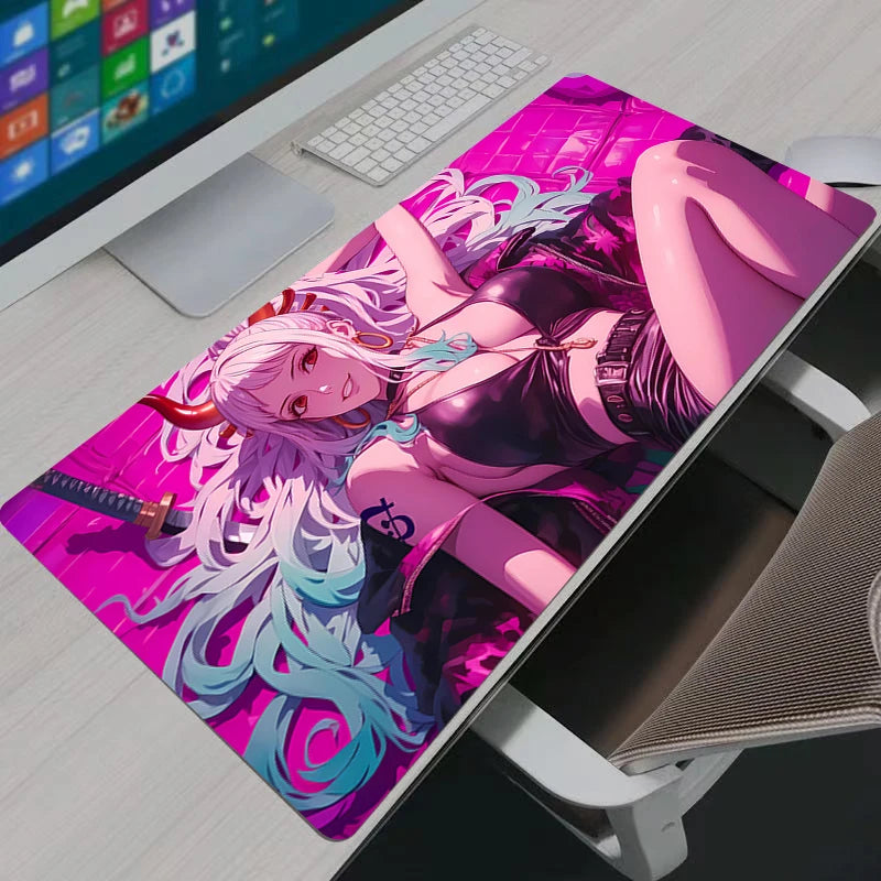Vibrant neon pink Yamato One Piece XXL gaming mouse pad on a modern white desk setup.