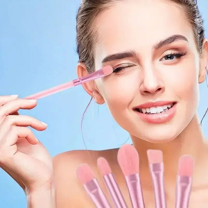 Woman applying eyeshadow with a soft pink synthetic brush from the 13-piece premium set.