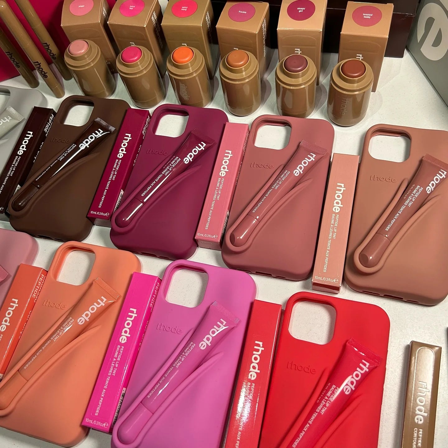Collection of Rhode peptide lip treatment products including various tints and restorative balms.