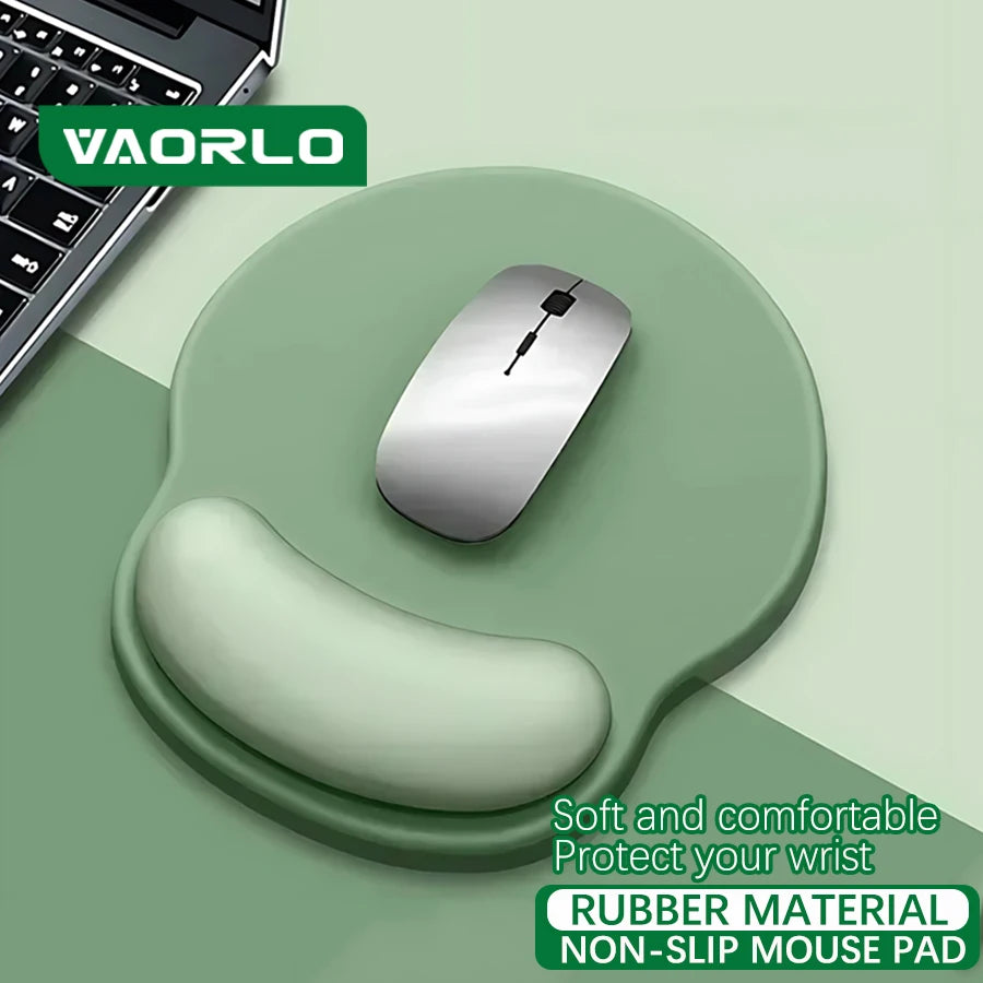 VAORLO soft sage green silicone mouse pad with integrated wrist rest and a silver wireless mouse.