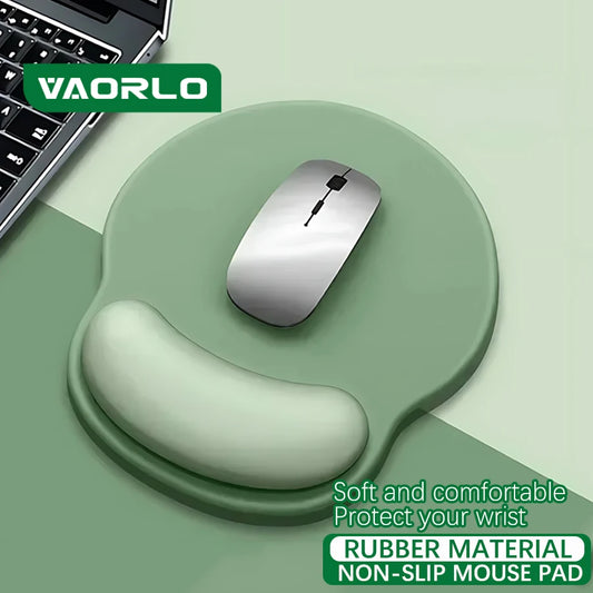 VAORLO soft sage green silicone mouse pad with integrated wrist rest and a silver wireless mouse.
