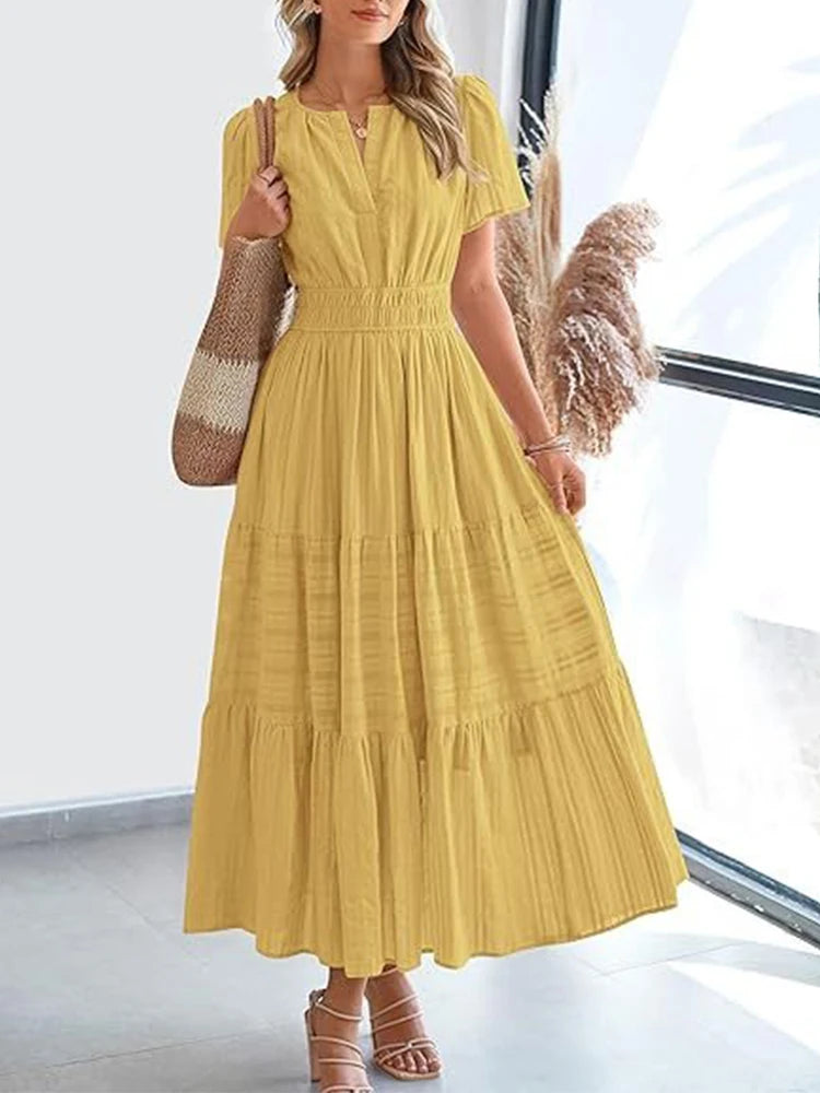 Sun-kissed yellow V-neck midi dress with layered swing skirt and textured bubble sleeves for summer fashion.