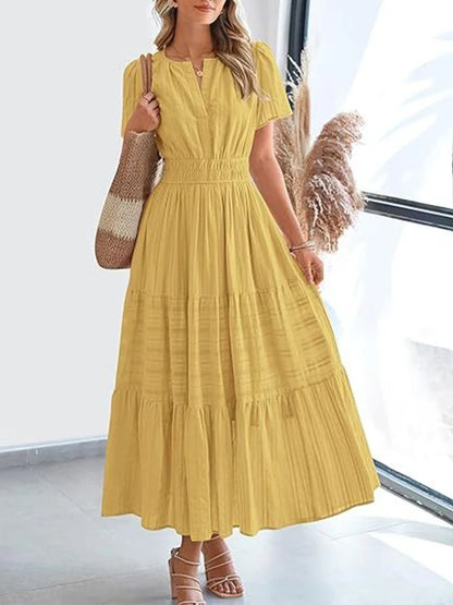 Sun-kissed yellow V-neck midi dress with layered swing skirt and textured bubble sleeves for summer fashion.